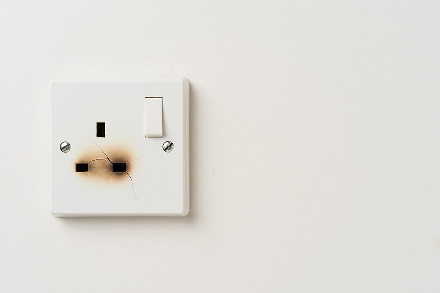 A wall socket that has stopped working due to damage.