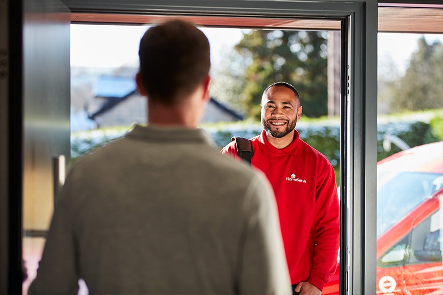A HomeServe gas safe registered engineer arriving at a property.