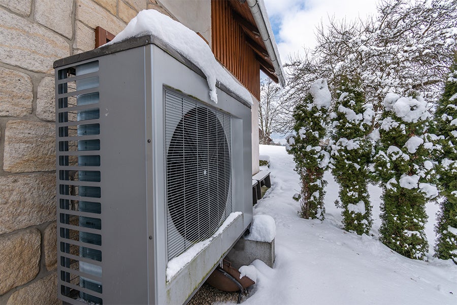 A heat pump covered with snow