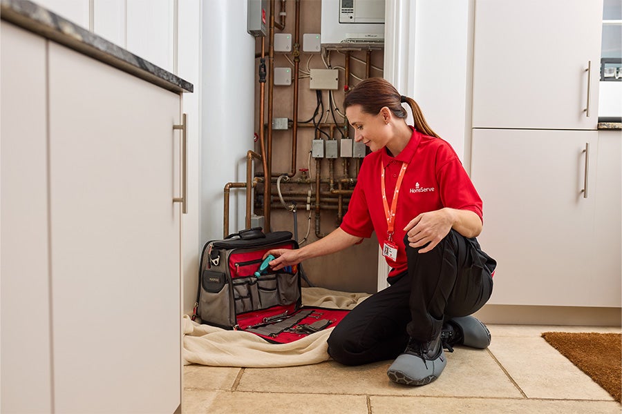 A HomeServe engineer getting ready to repair a boiler.