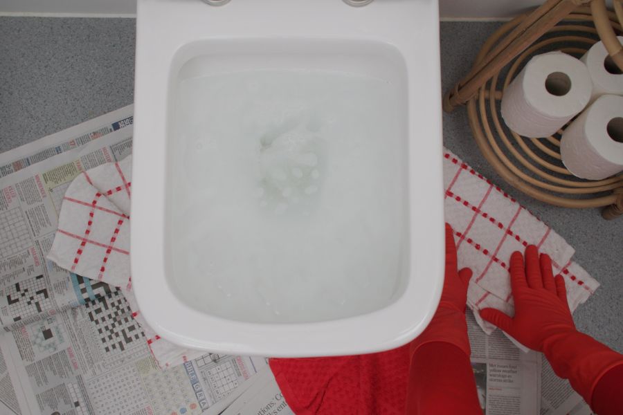 The area around a blocked toilet being protected before being unblocked.