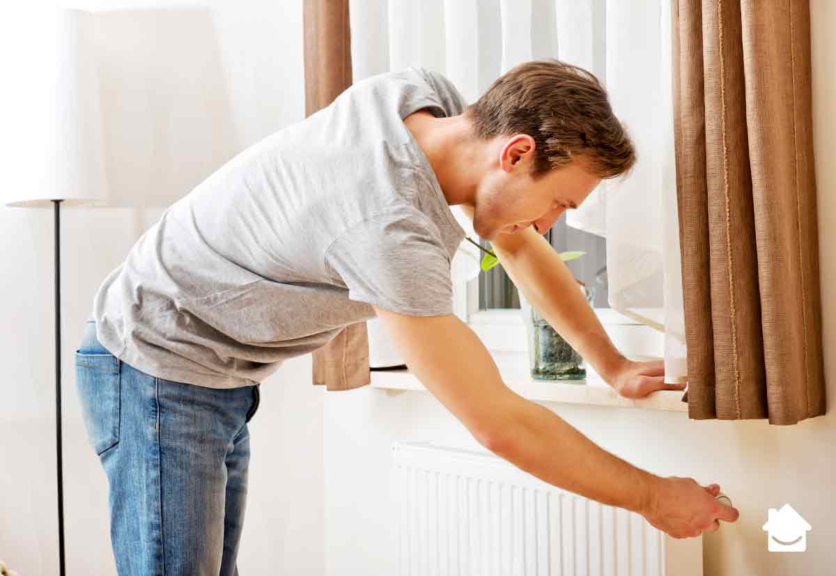 Boiler works but radiators stay cold - man turning on radiator valve