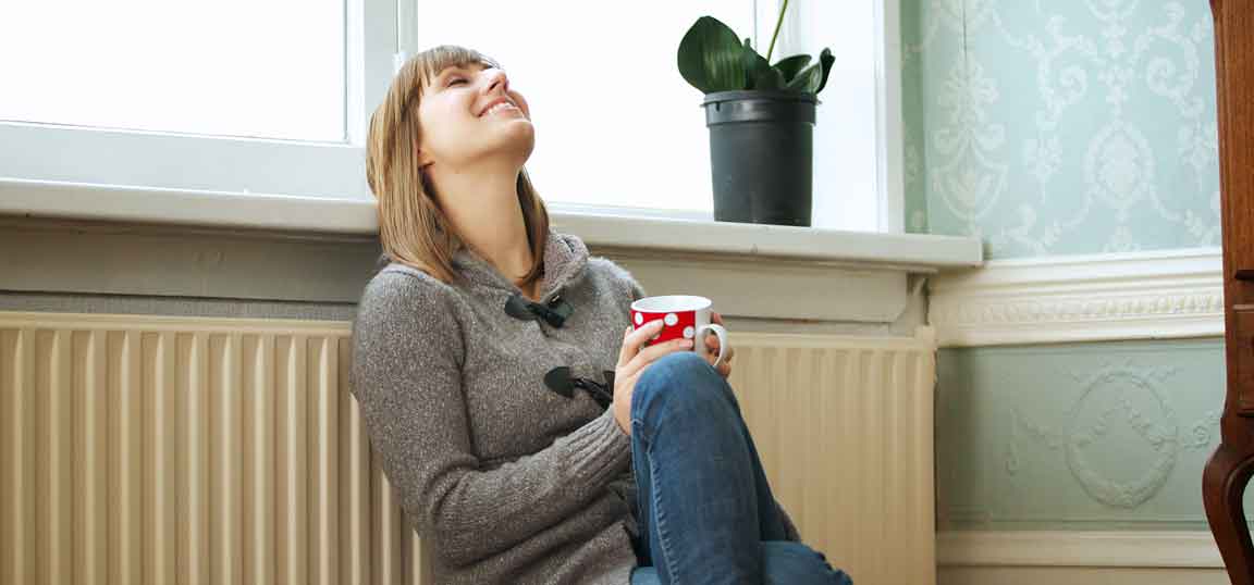 Woman leaning on radiator
