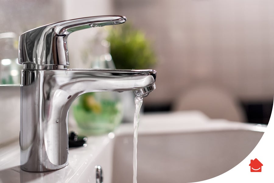 A tap running water into a sink. It has just undergone repairs due to a problem with the tap dripping.