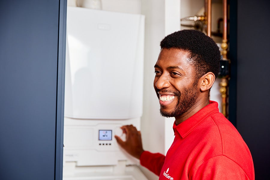 A HomeServe Gas Safe registered engineer working on a customer's boiler.