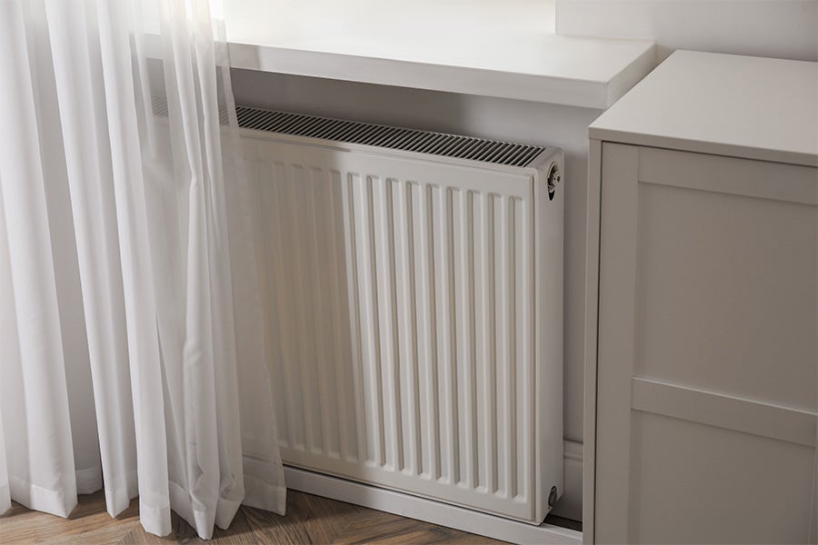 A double radiator underneath a window ledge.