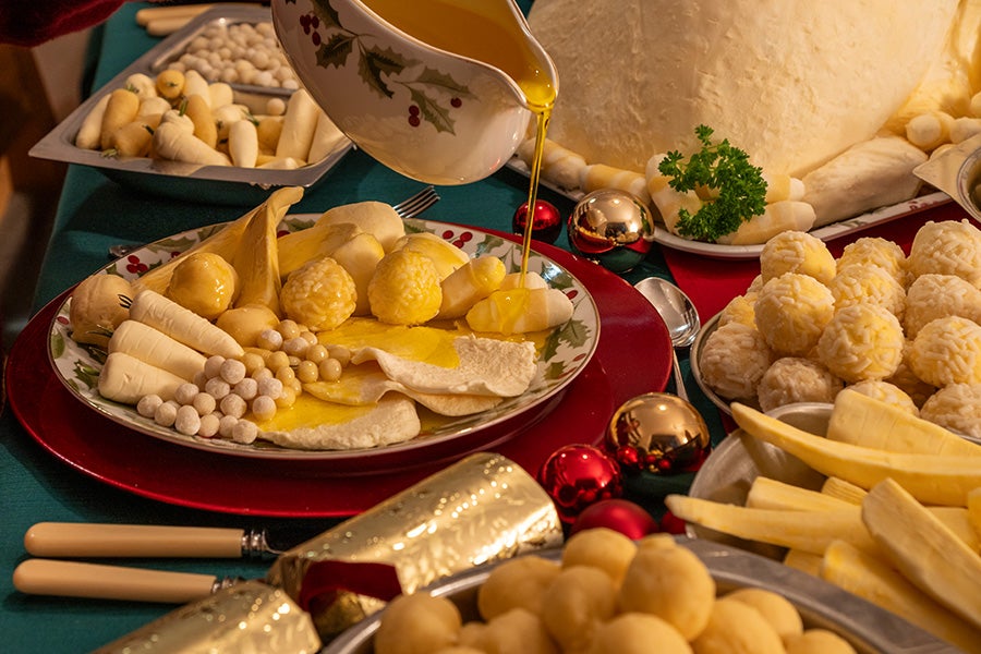 Oil being poured over a Christmas dinner made from fat and oil.