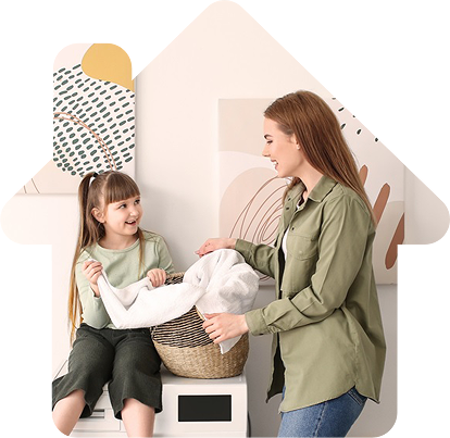 Decorative image of a mother and daughter smiling while doing laundry, framed within a cut-out shaped like a house to emphasize a cosy, homey atmosphere.