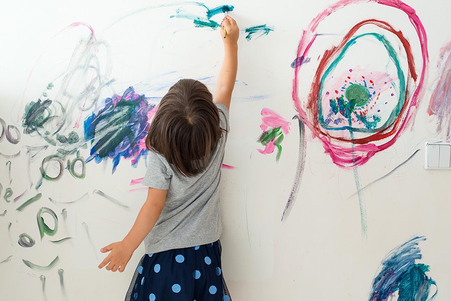 A child drawing on a wall