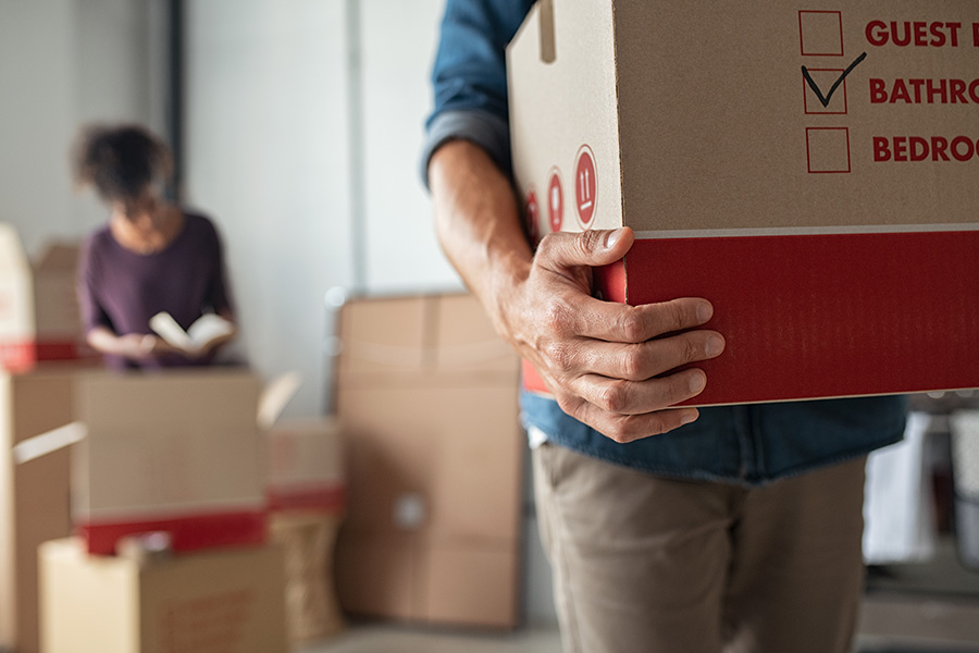Two new homeowners unpacking boxes in their new home.