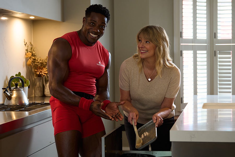 Harry Aikines-Aryeetey showing someone how to properly dispose of kitchen grease in the bin. 