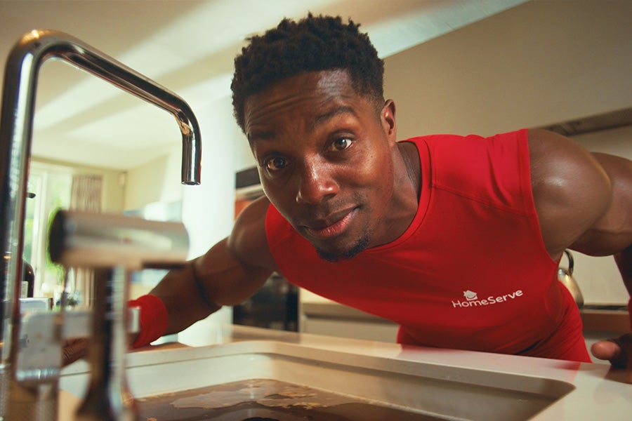 HomeServe's Personal Drainer leaning over a blocked sink.