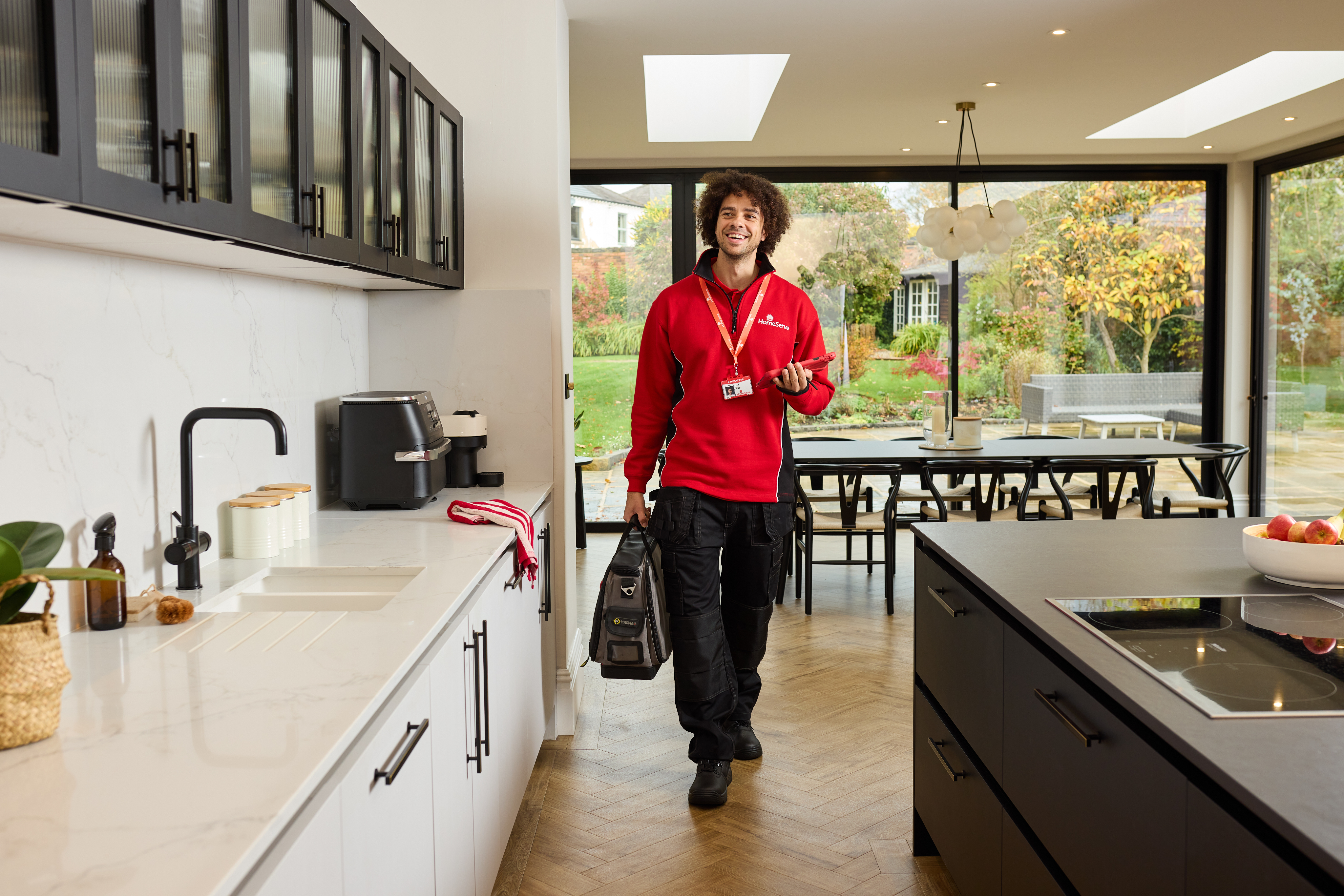 A HomeServe engineer in a customer's home assessing a repair.