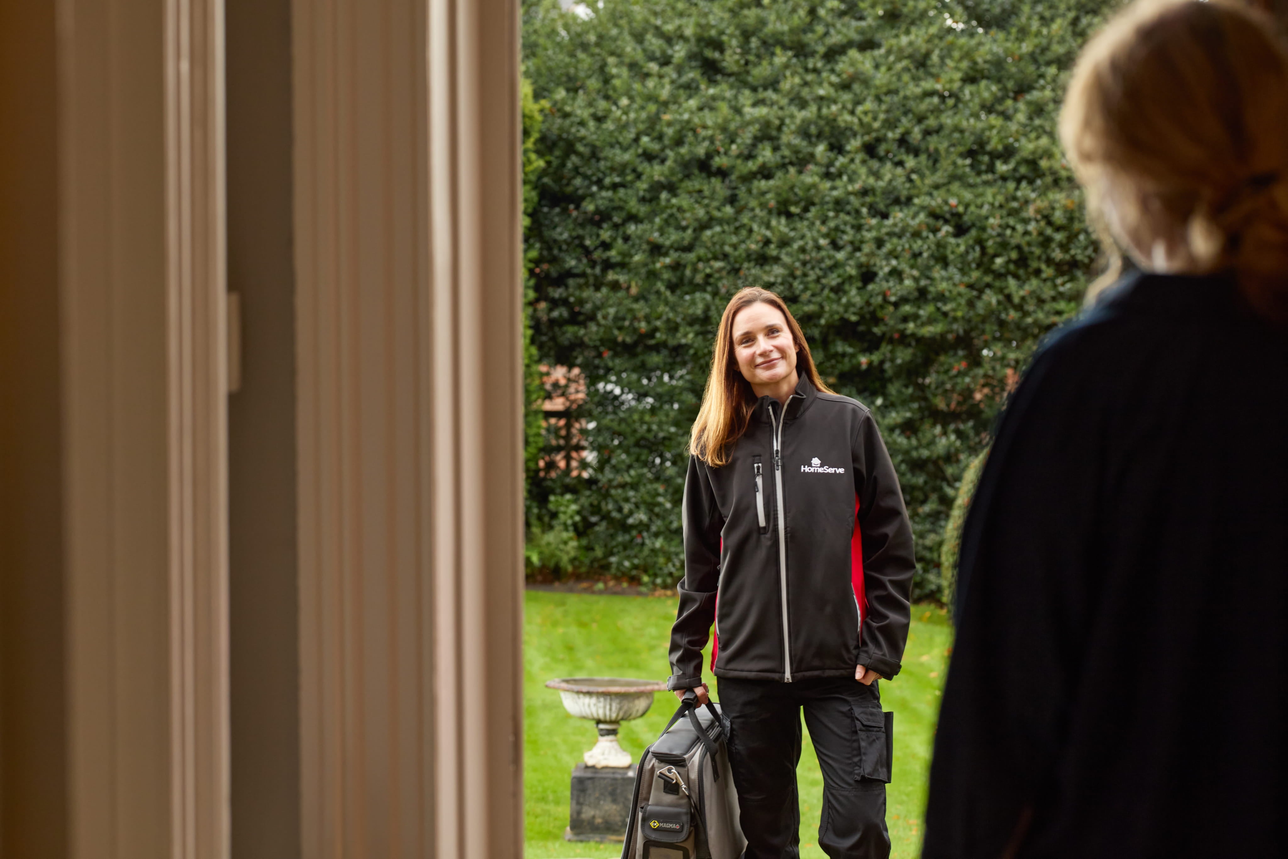 A HomeServe engineer arriving at a customer's home to resolve a home emergency.