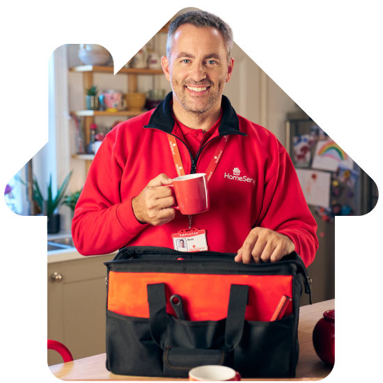 A HomeServe heating engineer pulling a cup of tea from his tool bag.