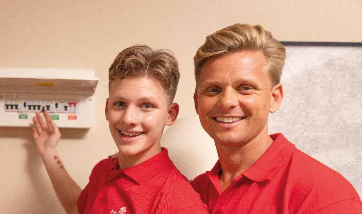 Jeff and Freddie Brazier inspecting a fusebox.