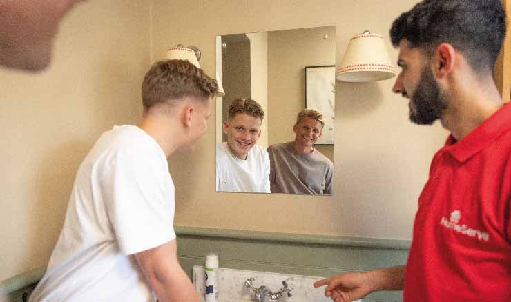 A HomeServe Engineer teaching Freddie Brazier how to fix a leaky tap.