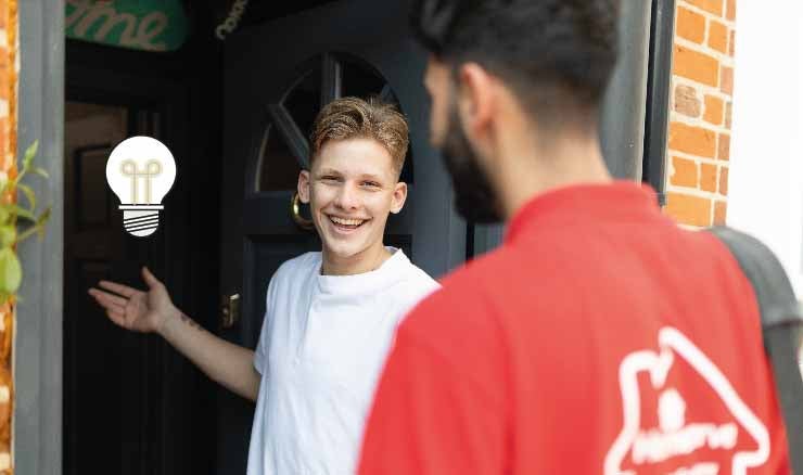 Freddie Brazier welcoming a HomeServe Engineer into his home. A lightbulb graphic is in the background.