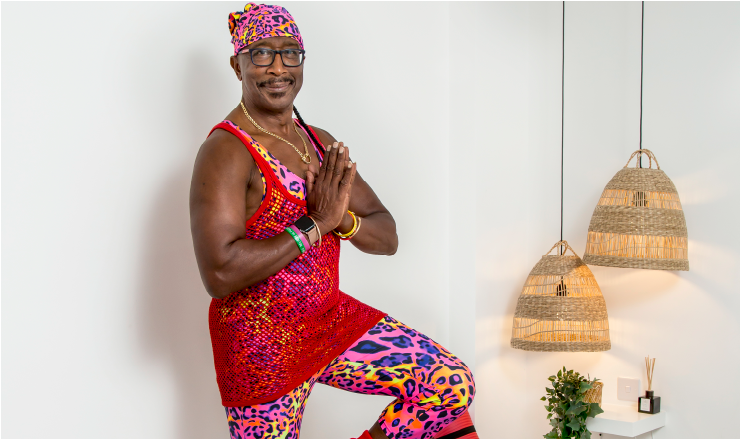 90's icon, Mr. Motivator performing the yoga tree pose.