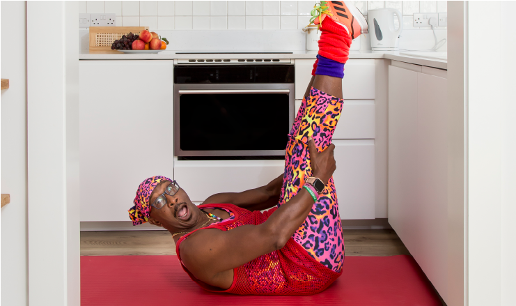 90's icon, Mr. Motivator in a yoga boat pose.