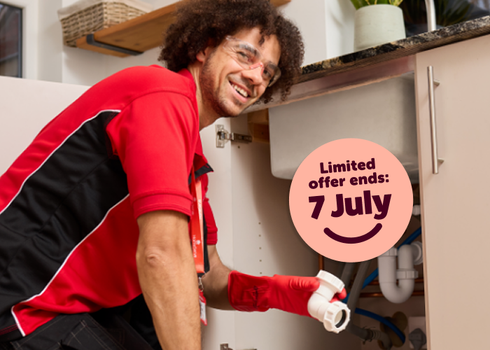 A HomeServe plumber fitting a new waste pipe under a sink next to a message reminding customers that the 50p a month limited offer ends 7 July