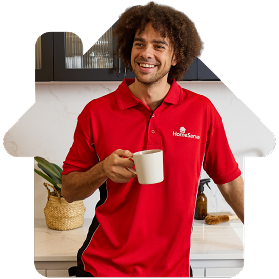 A smiling HomeServe plumber holding a cup of tea