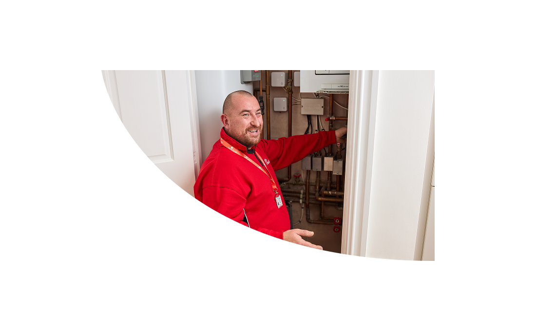 A HomeServe heating engineer topping up the pressure of a combi boiler after a repair