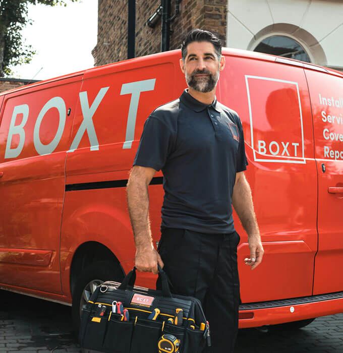BOXT engineer standing next to a red BOXT van