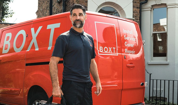 Engineer standing next to BOXT van