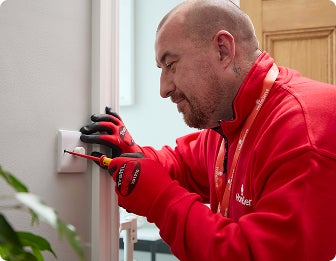 A HomeServe engineer repairing a dimmer switch.