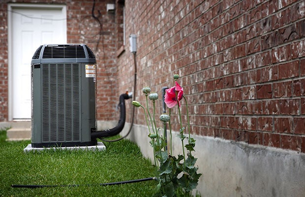 Heat pump standing outside of property