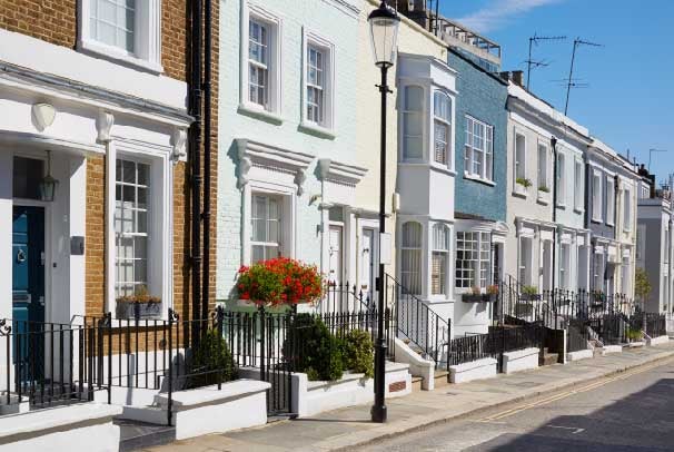 A street of coloured terraced houses owned by landlords