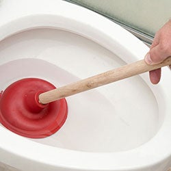 unblocking a toilet