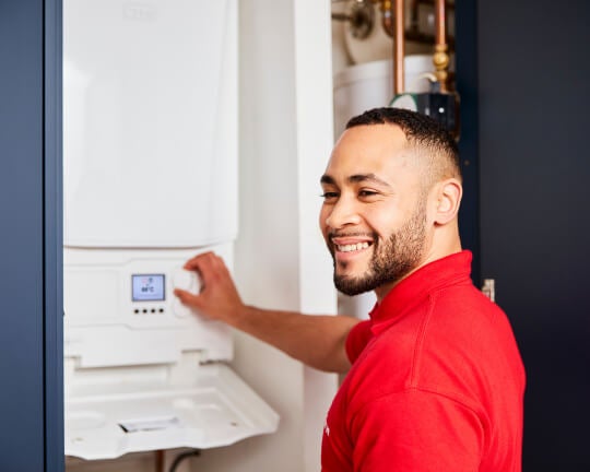 An engineer installing a new combi boiler